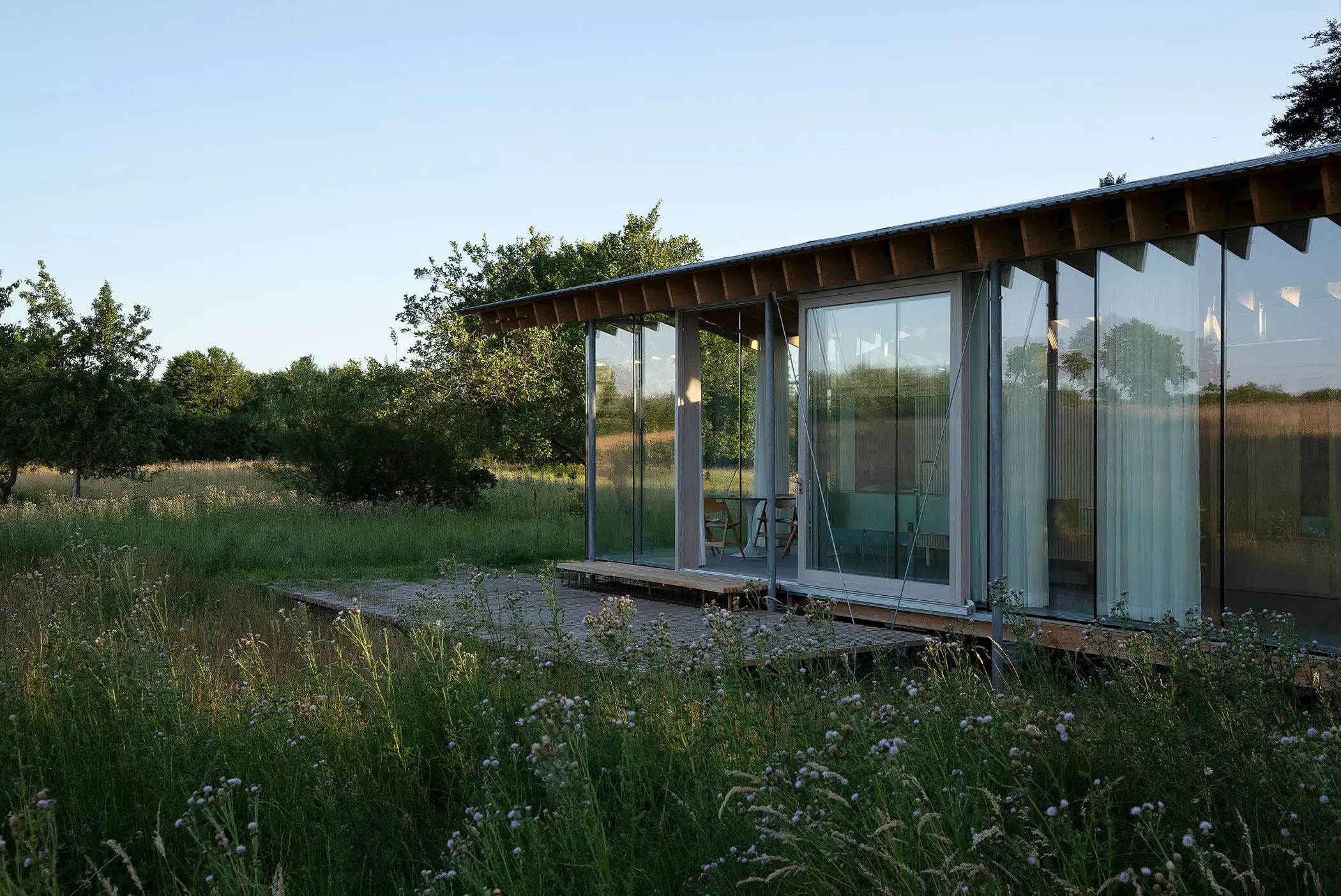 Ferienhaus aus Glas auf einer Wiese – femtastics