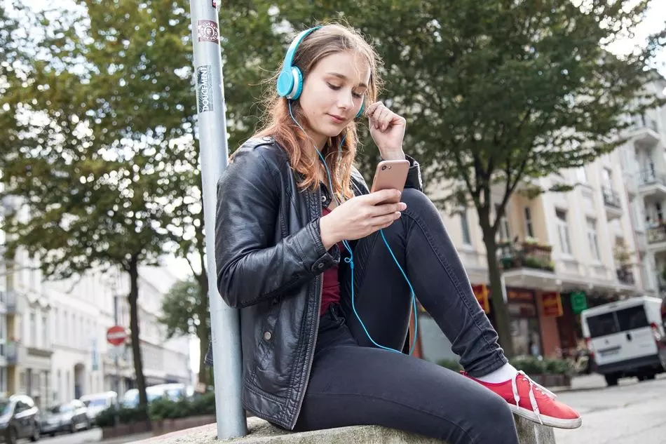 Mädchen mit Kopfhörern und Smartphone